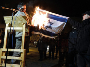 Anti-Israel Demonstration. Der unabhängige Parlamentsabgeordnete Balázs Lenhardt bei der Verbrennung der Israel-Fahnen in Budapest.